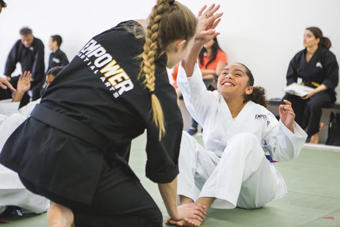 girl high fiving instructor