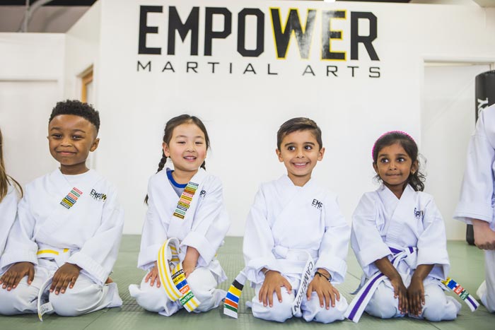 young kids sitting during martial arts class