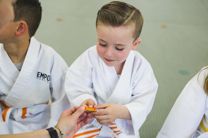 boy receiving family badge